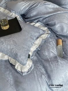 a tray with a drink on top of a bed