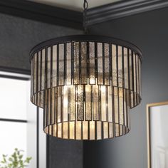 Stellar over a formal entry or dining room, this 2-tiere small chandelier brings a showy modern flair with an array of softened glow. With a classic flat black finish and clean silhouette, the small drum chandelier features several pieces of glass that smoothly dangle to form a 2-tiere shape. The lighting travels through the hand-blown glass with beautiful patterns, playing a unique visual interest. Brimming with a modern touch, this chandelier looks right in your dining room, entryway, stairwel Entry Chandelier, Entryway Chandelier, Chandelier Glass, Black Dining Room, Foyer Lighting, Irregular Patterns, Chandelier Bedroom, Drum Chandelier