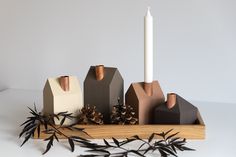 a candle and some small houses on a table