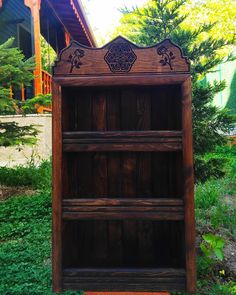 an old wooden bookcase sitting in the grass