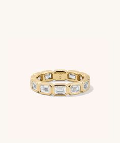 a yellow gold ring with baguets and diamonds