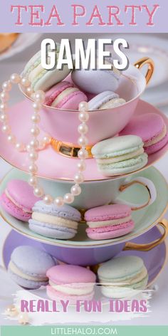 a stack of plates topped with macaroons and cupcakes