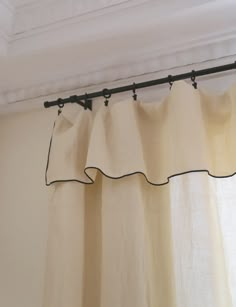 the curtains are hanging on the rod