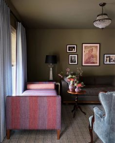 a living room filled with furniture and pictures on the wall