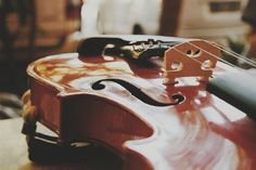 an old violin sitting on top of a table