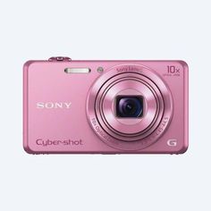 a pink digital camera sitting on top of a table