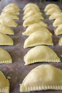 several ravioli shells lined up on a baking sheet