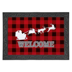 a welcome mat with santa sleigh and reindeers in red, black and white