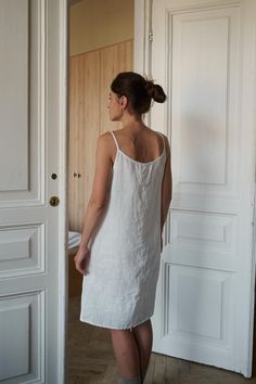 Mini slip nightgown linen dress. This pyjama dress has a flowy A-line design, making it light and airy for comfortable sleep. The round neckline is decorated with vertical stitching. Easy fit, midi length, delicate slender straps, and a seam in the back. SIZING AND FIT This garment is true to size, and we recommend choosing the size you usually wear. If you want the garment to be loose-fitting, choose a larger size than you usually wear. Before placing an order, check the approximate measurement Slip Dress Sleepwear, Pyjama Dress, Dress Sleepwear, Slip Nightgown, White Linen Dress, White Linen Dresses, Pajama Dress, Summer Pajamas, Mini Slip