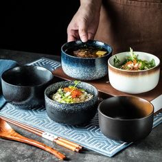 a table topped with bowls of food and chopsticks