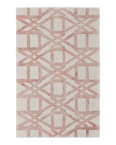 a pink and white rug with an abstract design