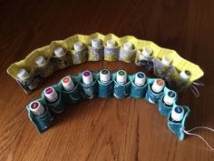 several different types of sewing thread on a wooden table