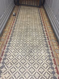 an ornate tiled floor in a hallway