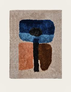 an abstract rug with blue, brown and black shapes on it's sides in the shape of a flower