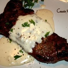 steak with gravy and mashed potatoes on a white plate at casie's restaurant