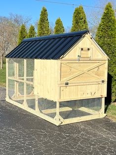 a chicken coop sitting on the side of a road