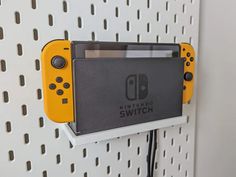 a nintendo wii game console mounted to a wall with the nintendo switch logo on it