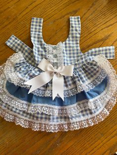 a blue and white dress sitting on top of a wooden floor