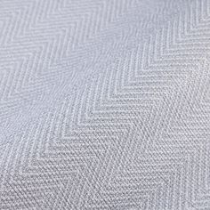 an upholstered fabric with herrings in grey and white colors, closeup