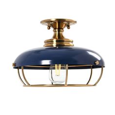 a brass and blue light fixture with a glass bulb on the top, against a white background