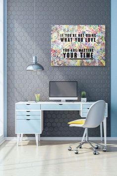 a white desk with a computer on top of it in front of a gray wall