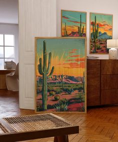 there are three paintings on the wall in this room, each with a cactus theme