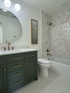 a bathroom with green cabinets and a white toilet