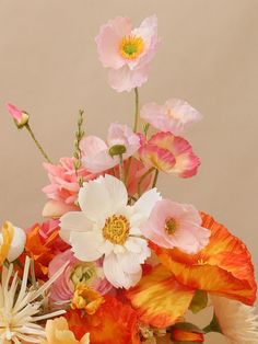 a vase filled with lots of different colored flowers