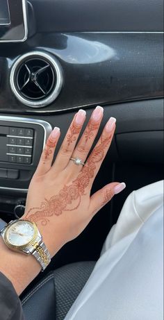 a woman's hand with hendike on her wrist in the passenger seat of a car