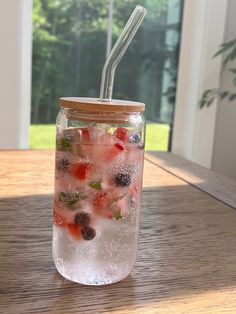 a mason jar filled with water and berries