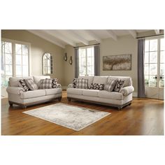 a living room filled with furniture on top of a hard wood floor