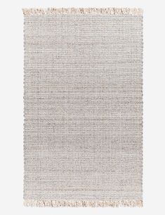 a beige rug with fringes on it