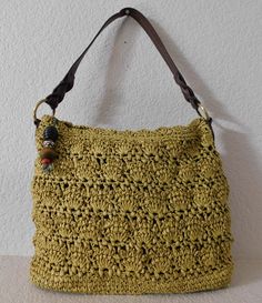 "Mustard color shoulder/tote bag- looks like hand knitted Light weight Gold tone hardware 100% paper and vinyl trim Brown fabric lining Two interior open pockets - one zipper pocket the other open pocket Zipper closure - zipper handle with wood decor Great condition Dimension length 15.5: height 12\" depth 5\" strap drop 9\"" Casual Yellow Crochet Bag With Braided Handles, Casual Yellow Crochet Woven Bag, Casual Yellow Shoulder Bag With Braided Handles, Yellow Casual Straw Bag For Daily Use, Yellow Casual Crochet Bag For Spring, Casual Yellow Straw Bag For Daily Use, Casual Yellow Crochet Bag For Spring, Casual Yellow Woven Beach Bag, Casual Yellow Woven Bag