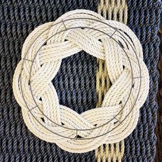 a white rope on top of a blue rug