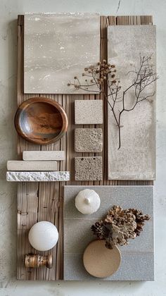 an assortment of ceramic and wood pieces on display in a room with white wallpaper