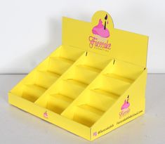 a yellow cardboard display case with pink frosted cupcakes on the top and bottom