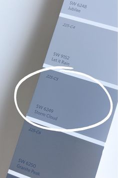 a white circle is in the middle of some gray paint swatches