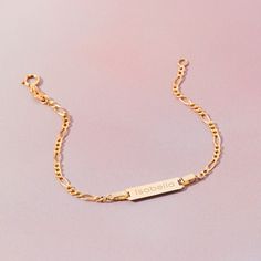 A classic engravable tag id bracelet for baby girls and boys that features an elegant figaro chain. This bracelet is crafted from genuine 14k yellow gold, a material that is safe for your baby with sensitive skin. This classic bracelet makes for a beautiful gift for a baby or toddlers special birthday. Gift box included with purchase. Age Group: Lovely Gifts For Babies and Toddlers Material: 14k Yellow Gold Bracelet Length: 5.5 inches (13.9 cm) Tag Size: 18mm W x 5mm H Metal Stamp: 14k Gift Box Included Bracelet For Baby Boy, Baby Boy Bracelet Gold Kids, Gold Circle Ring, Classic Bracelets, Kids Bracelets, Figaro Chains, Id Bracelets, Circle Ring, Yellow Gold Bracelet