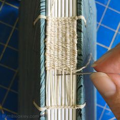 someone is tying the string on top of an old book with twine and yarn