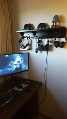 a flat screen tv sitting on top of a wooden desk next to a computer monitor