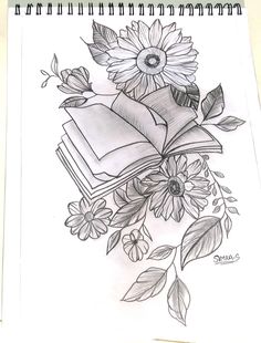 an open book with sunflowers and leaves on it