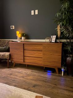 a living room with a large wooden dresser