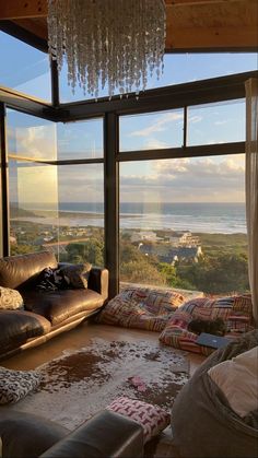 a living room filled with furniture and a chandelier hanging over the top of it