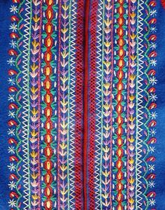 an embroidered fabric with colorful designs on it