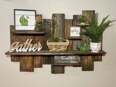 a wooden shelf with some plants on top of it and other items sitting on the shelves