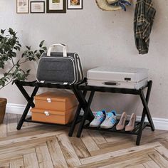 two suitcases are sitting next to each other on a shelf in front of a wall with pictures