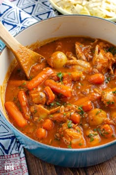 a bowl of stew with carrots and meat