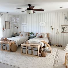 two twin beds in a bedroom with white walls and striped wallpaper on the walls