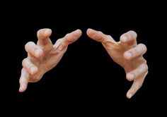 two hands reaching out towards each other with their fingers extended to form the letter v