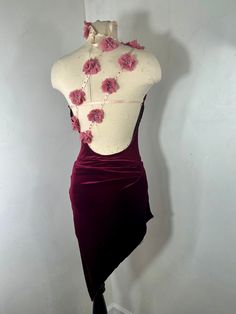 a mannequin wearing a dress with pink flowers on it's neckline